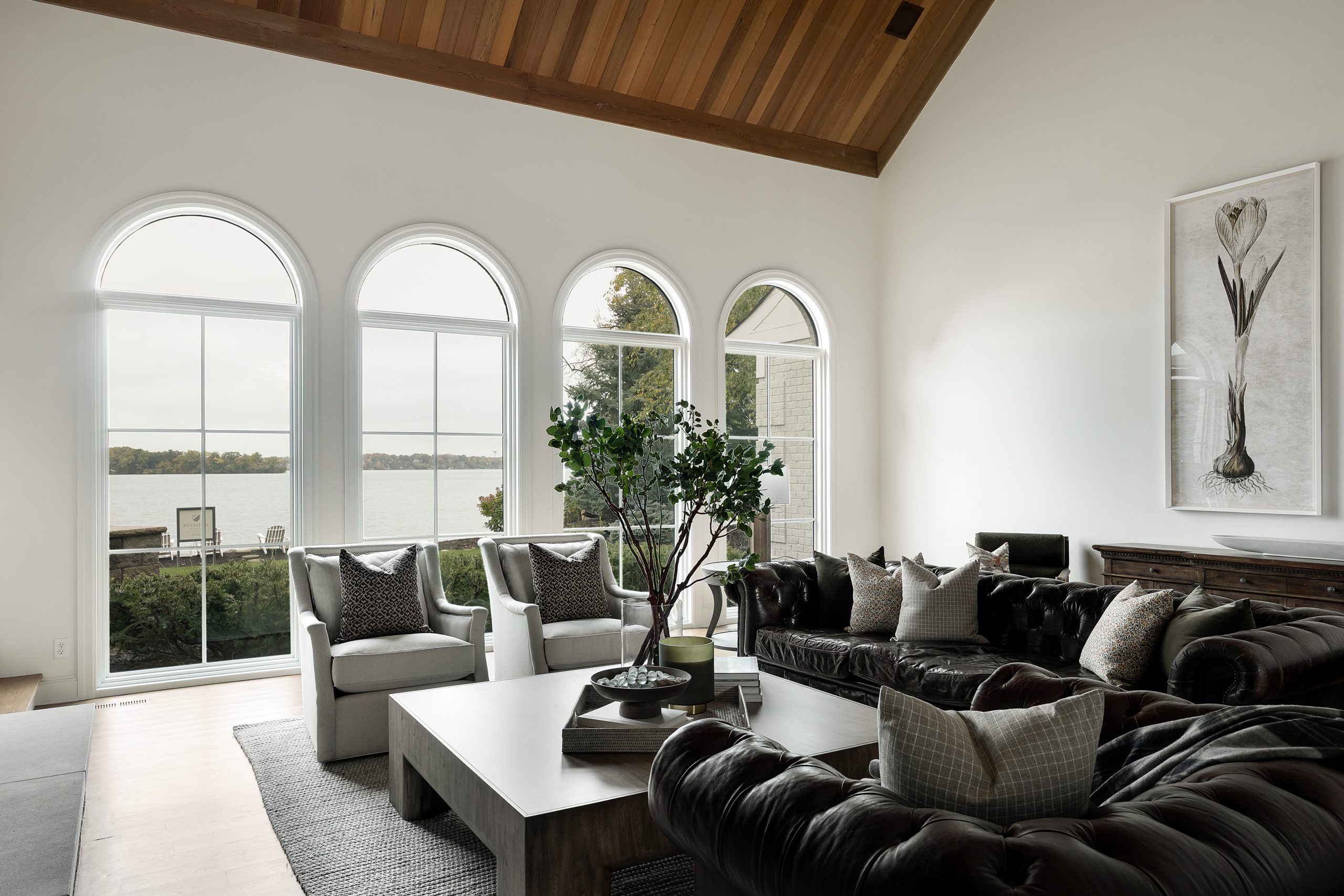 Living room with arched windows overlooking the lake