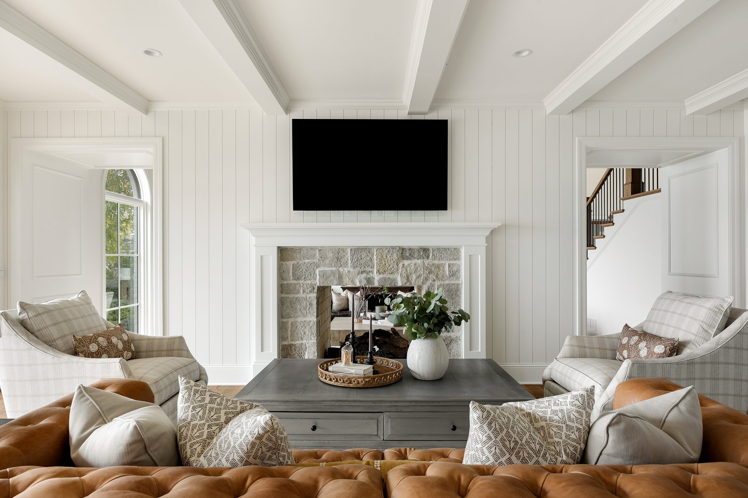 Living room with stone fireplace and lake views