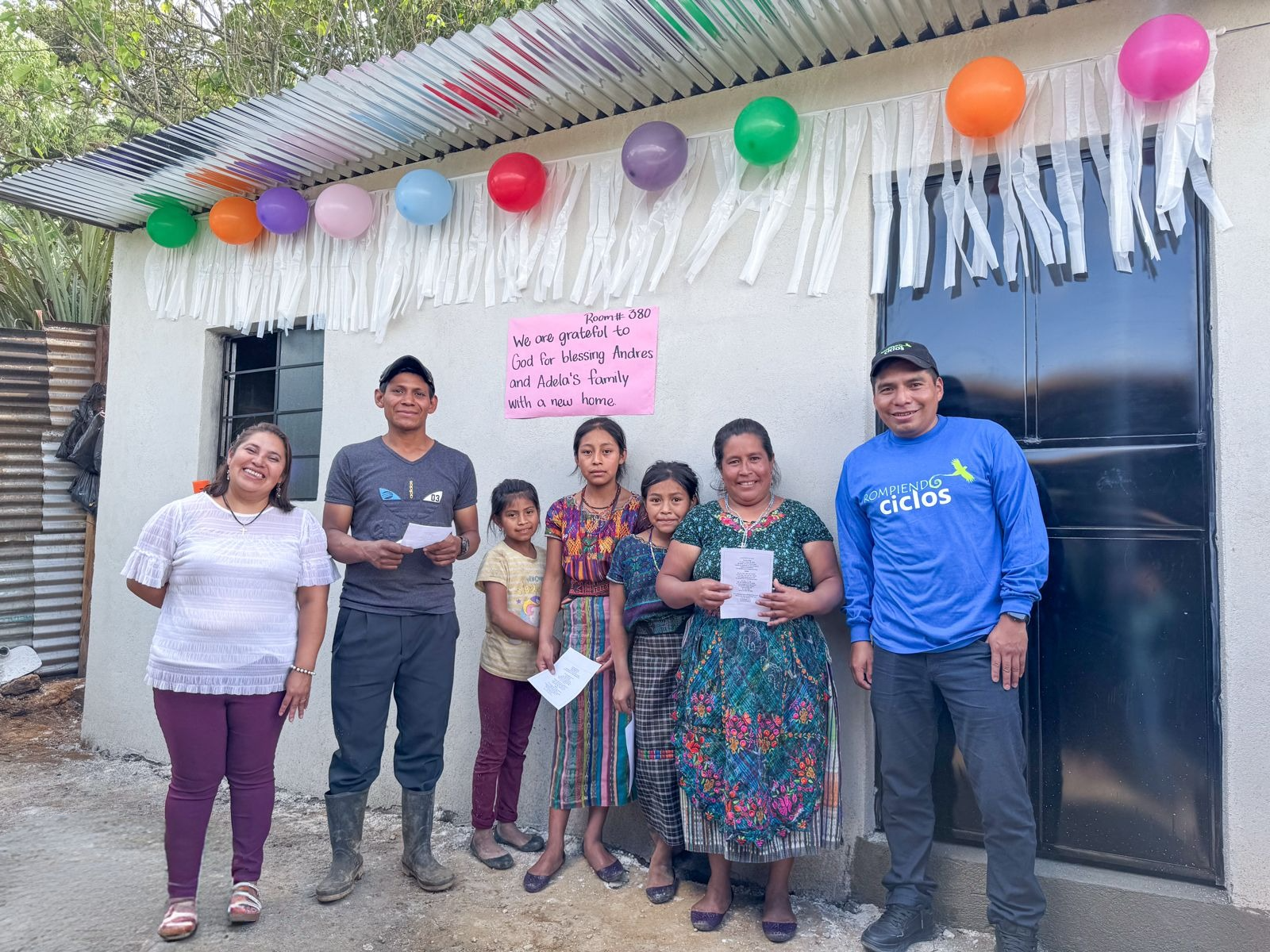 Andres and Adela's family outside their home